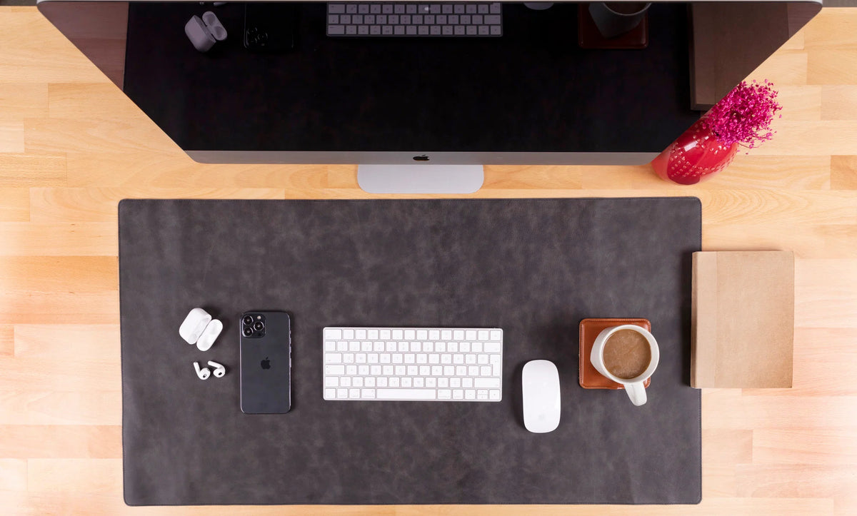 Almond Leather large desk mat shown from above with a keyboard, mouse and phone.
